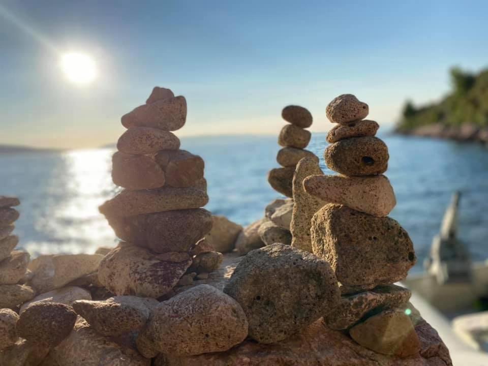 a pile of rocks sitting on top of the ocean at Cherso Mare in Cres