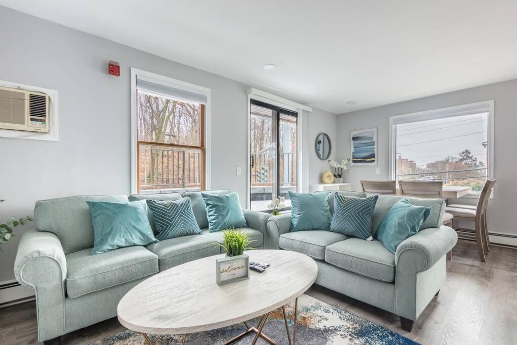 a living room with two couches and a table at Luxury 3Bed Private Apartment Near Manhattan in New Rochelle