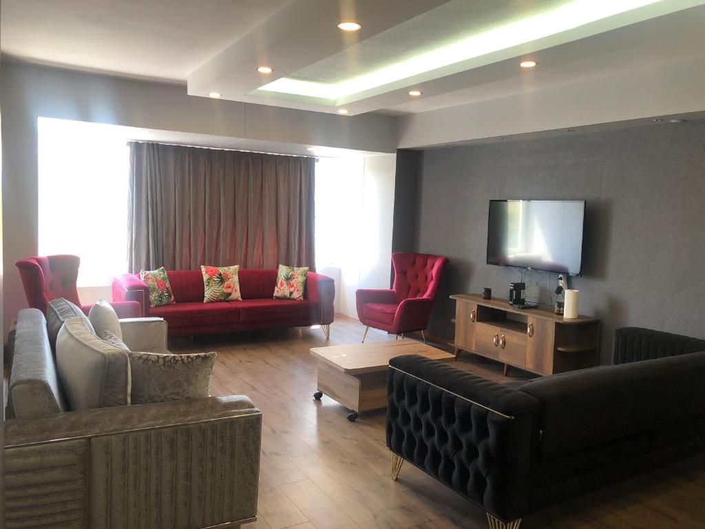 a living room with couches and a flat screen tv at Alsama Apart No 149 in Istanbul