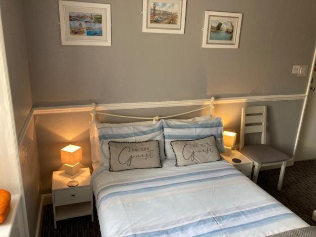 a bedroom with a bed with two pillows on it at Braemar in Weymouth