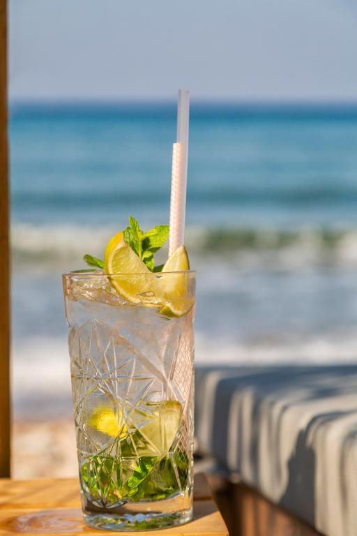 a drink with lemon and mint on a table at Erato by Samian Mare in Karlovasi