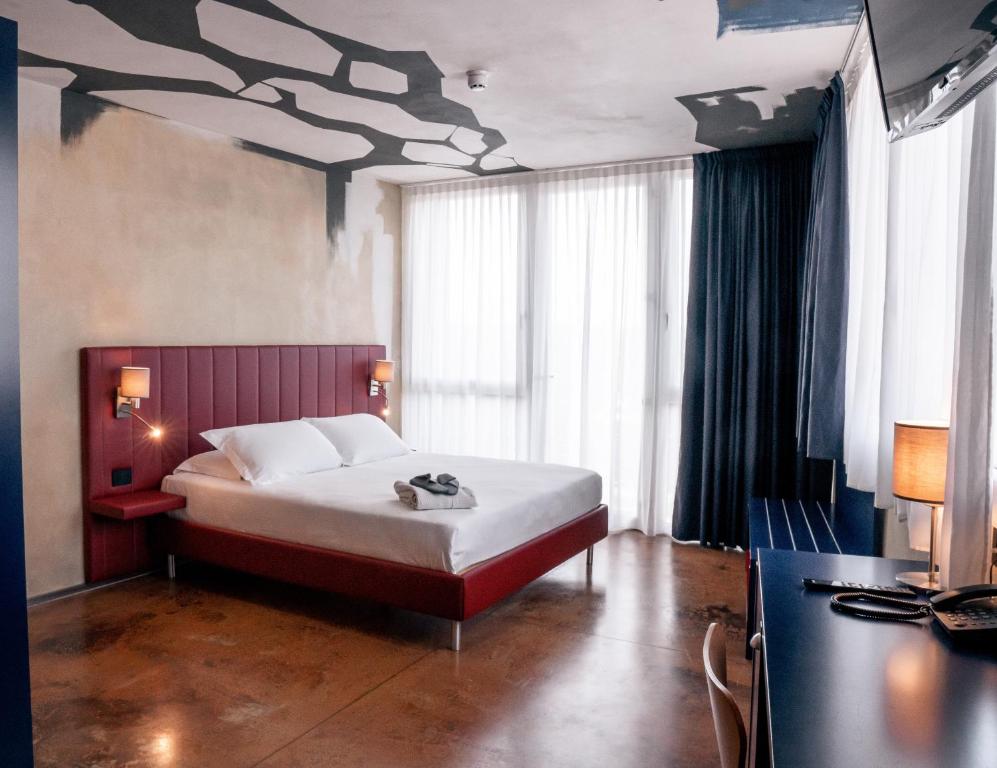 a bedroom with a bed with a painting on the ceiling at K MODERN HOTEL in Peschiera del Garda