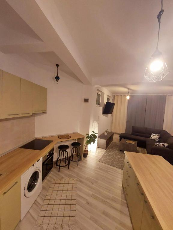 a kitchen and living room with a couch and a table at InTown in Constanţa