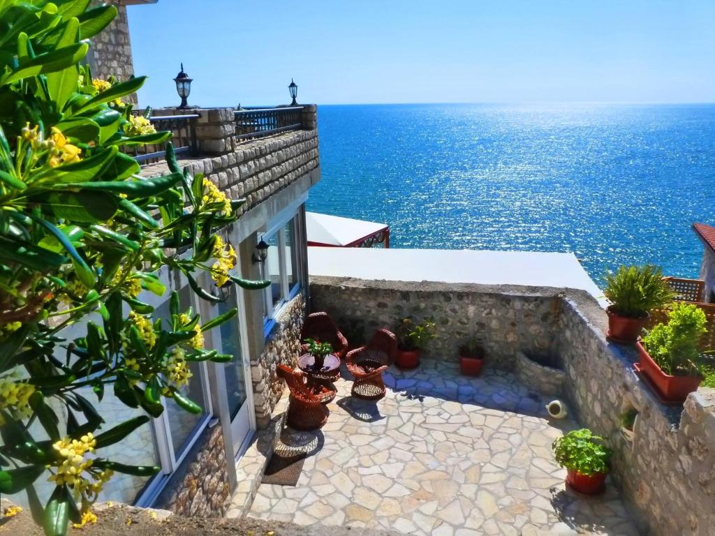 a view of the ocean from a building with plants at Apartments Antigona Old Town in Ulcinj