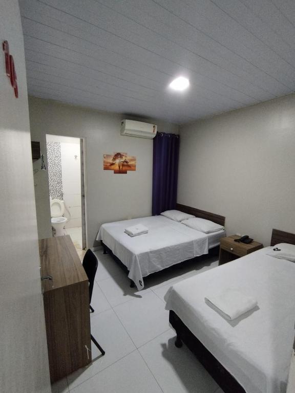 Postel nebo postele na pokoji v ubytování Hotel Resende