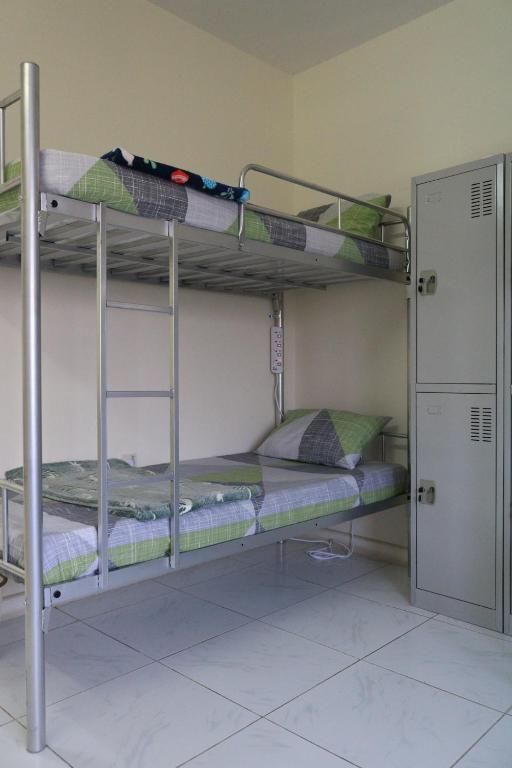 two bunk beds in a room with a door at Sakhra hostel in Dubai