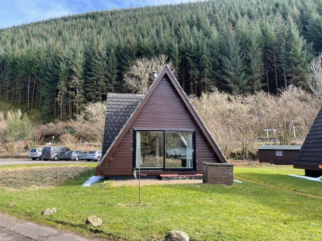 a small house with a gambrel roof at Caledonia Lodge in Spean Bridge