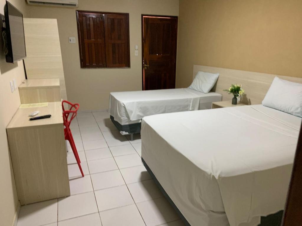 Postel nebo postele na pokoji v ubytování Hotel Sambaquis