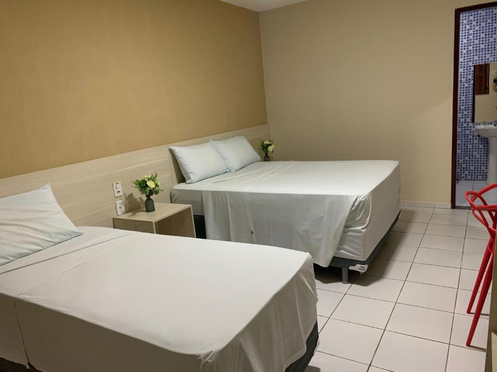 Postel nebo postele na pokoji v ubytování Hotel Sambaquis