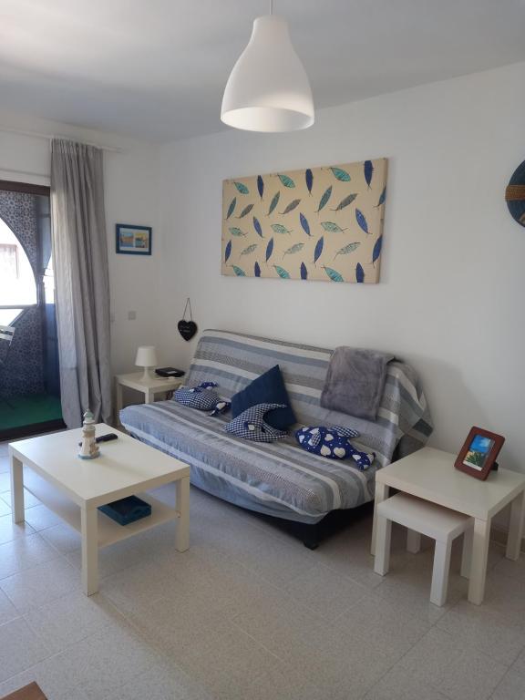 sala de estar con sofá y 2 mesas en Las Islas Apartment en Corralejo