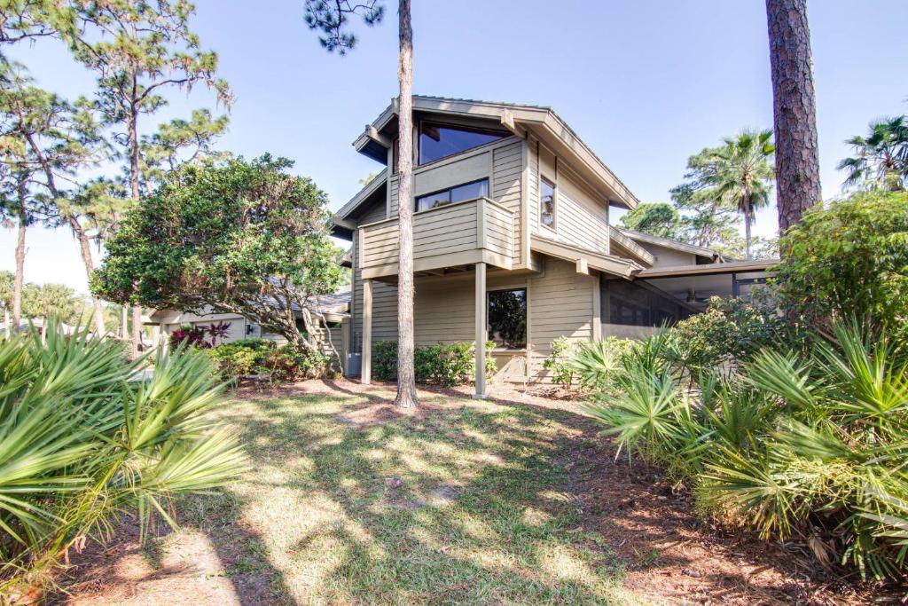 an exterior view of a house with palm trees at Canopy on Cobblestone in Wesley Chapel