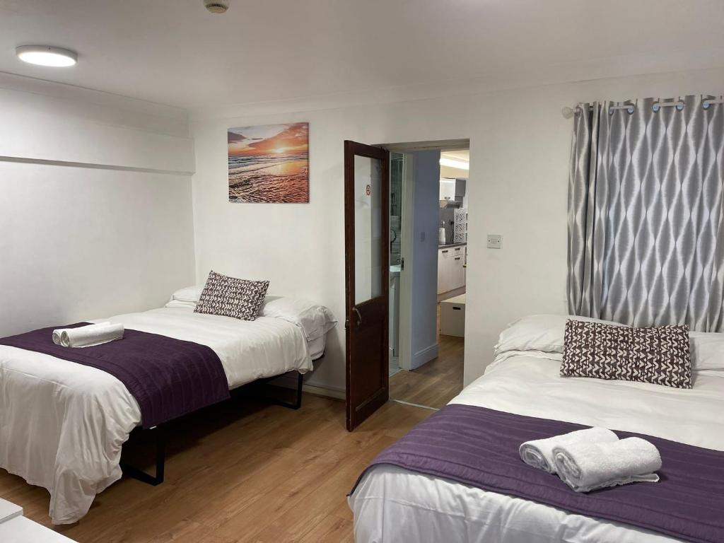 a hotel room with two beds and a mirror at Studio room in Brighton city centre in Brighton & Hove