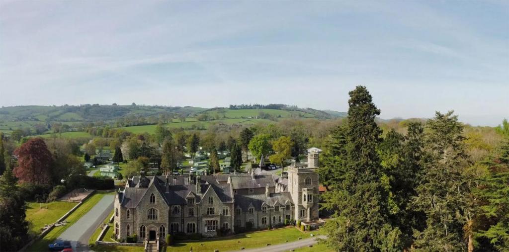 an aerial view of a large mansion with trees at Mellington Hall Country House Hotel in Church Stoke