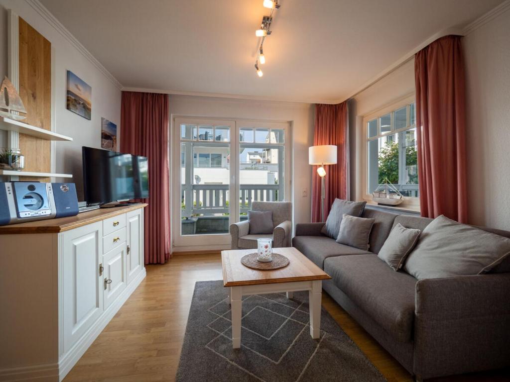 a living room with a couch and a table at Ferienwohnung 560 in der Villa Gudrun in Binz