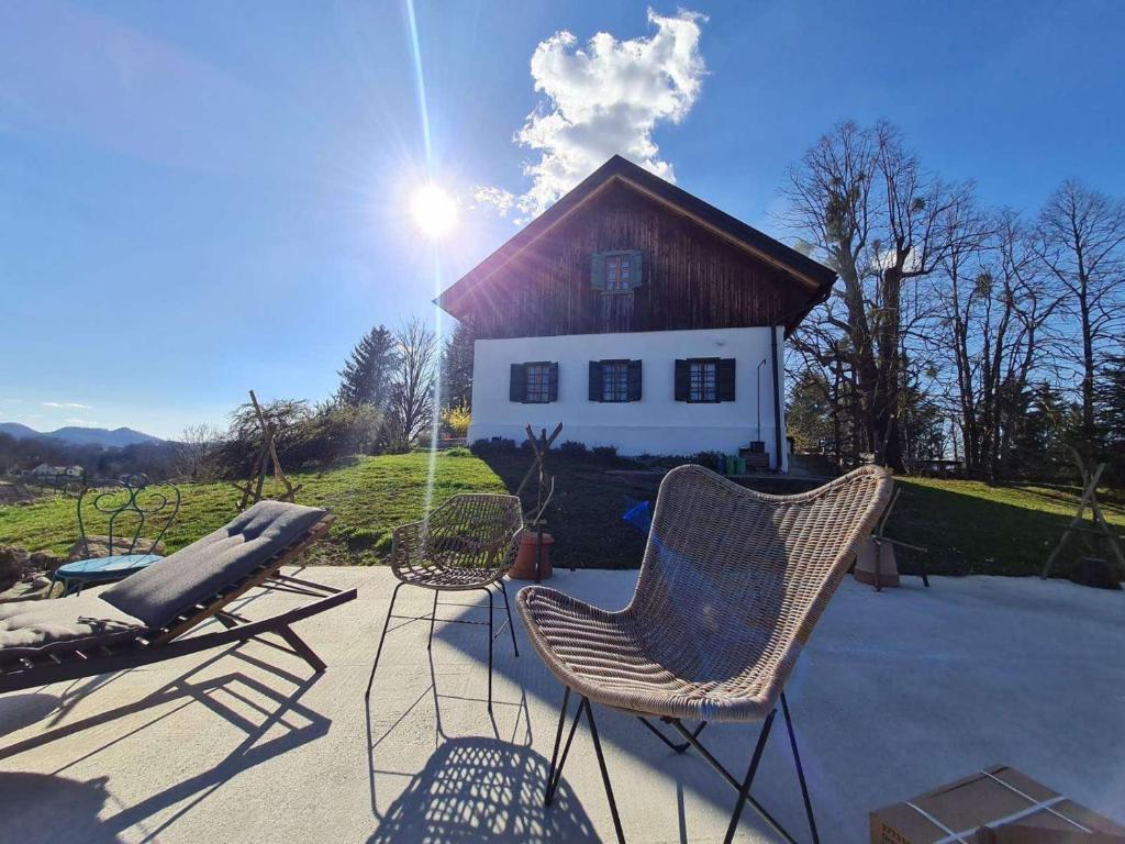 a patio with chairs and a house in the background at Estate Ana in Pristava