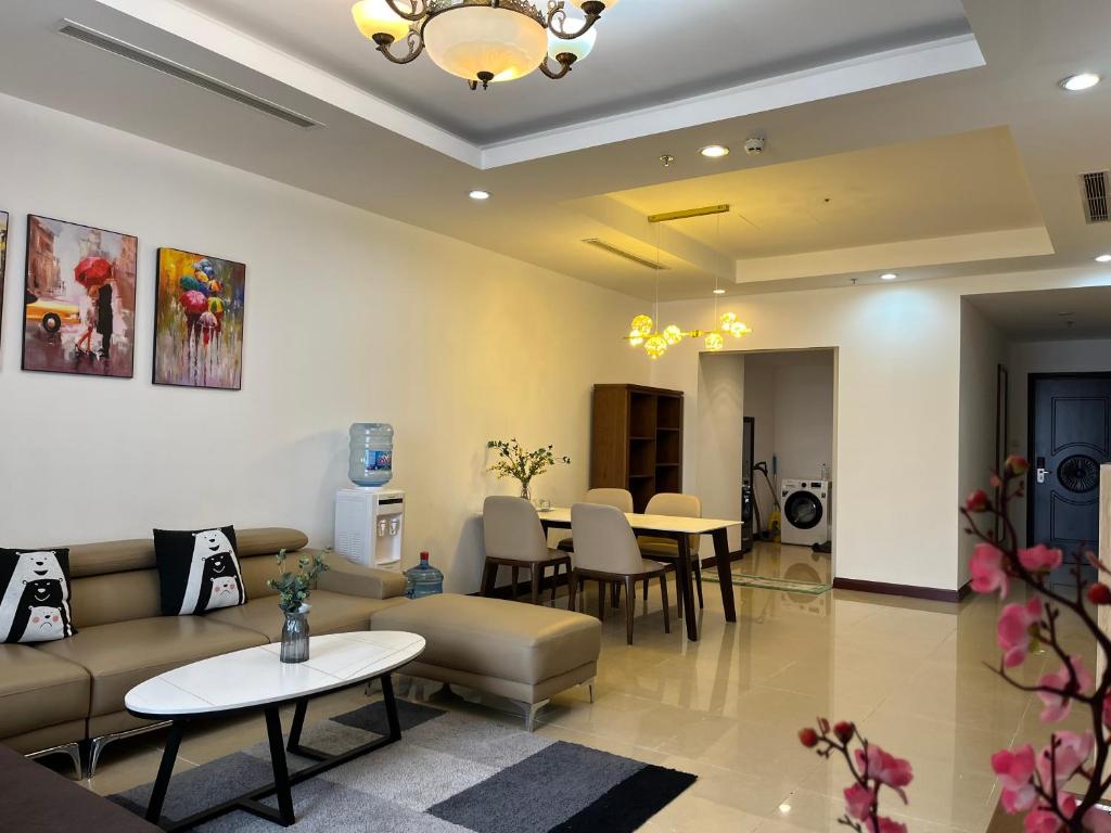a waiting room with couches and tables and chairs at Vinhomes Royal City Luxury Apartment 2 Br in Hanoi