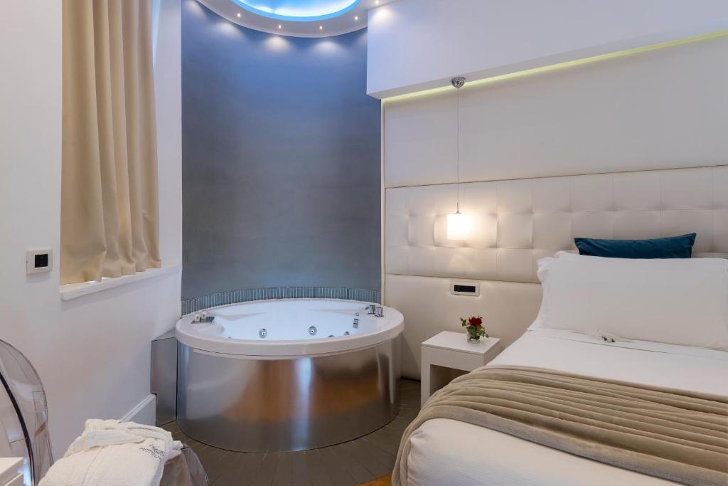 A bed or beds in a room at Argentina Residenza Style Hotel