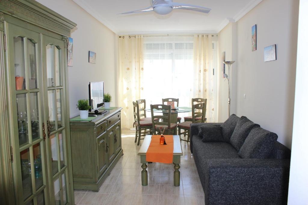 a living room with a couch and a table at Apartamento Mariposa in Torrevieja