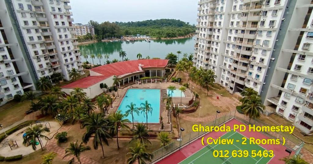 a view of a swimming pool in the middle of two apartment buildings at Gharoda PD Homestay CView in Kampong Baharu