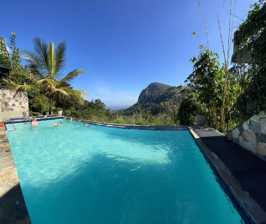 a swimming pool with a view of a mountain at Zion View Ella Green Retreat in Ella