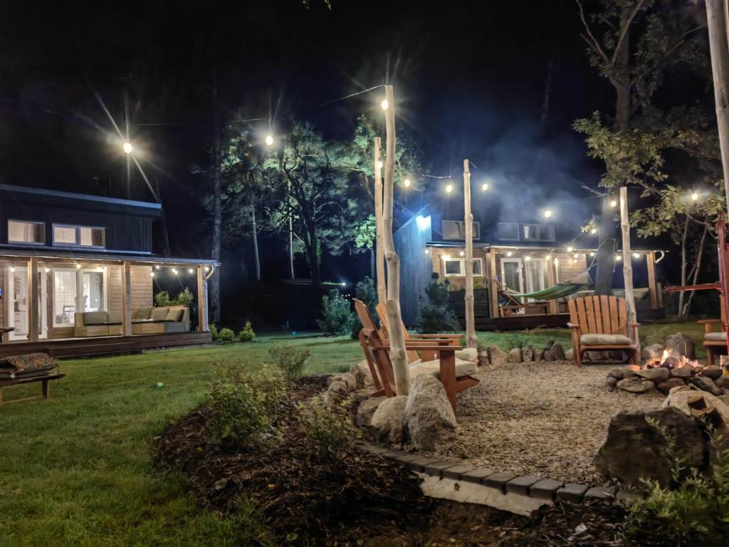 a yard with a playground at night with lights at Ragakrasts jaunie namiņi in Mērsrags