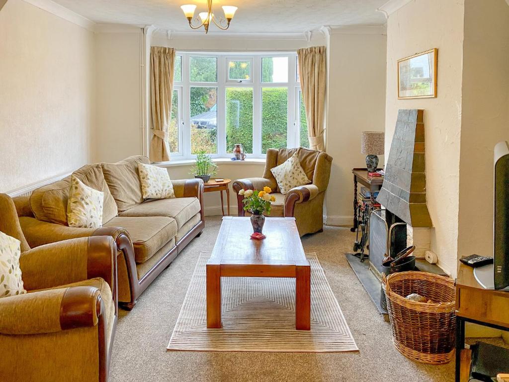 a living room with couches and a coffee table at Ewenny Cottage in Ewenny