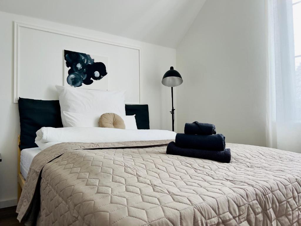 a bedroom with a large bed with a large headboard at Gallery Room 02 in Bielefeld
