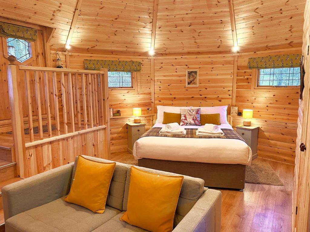 a bedroom with a bed and a couch in a cabin at High Parks in Bedale