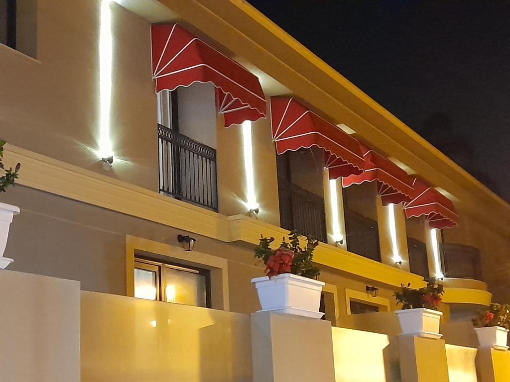 un edificio con banderas rojas a su lado en Mar Apartments Alicante, en Playa de San Juan