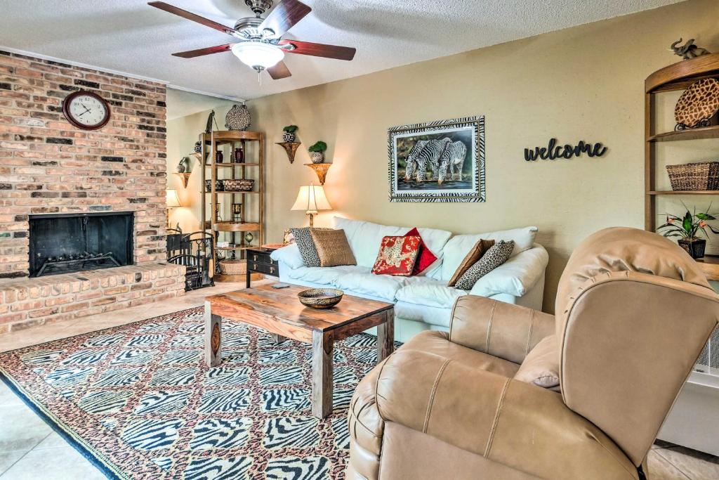 a living room with a couch and a fireplace at Gulf Breeze Vacation Rental 5 Mi to Beach! in Gulf Breeze
