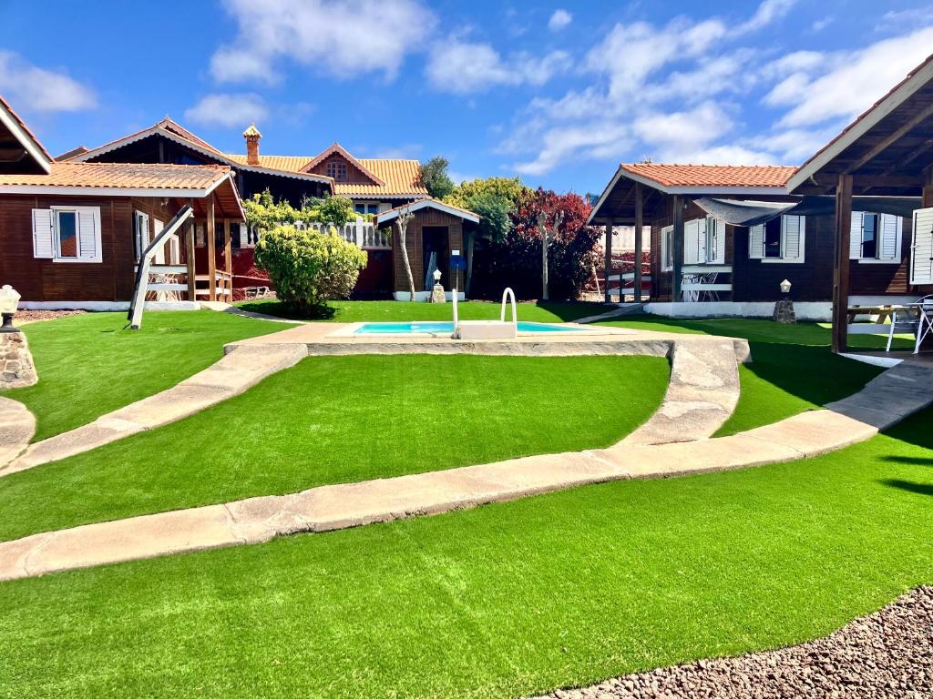 a lawn with a fountain in the middle of a yard at Casa Inmaculada Cabañas Mini Complejo Entero in Salobre