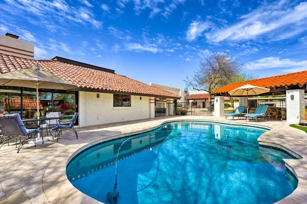 a swimming pool in the middle of a yard at Pet-Friendly Glendale Home with Pool and Putting Green in Phoenix