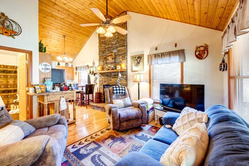 a living room with a couch and a fireplace at Scenic Marble Cabin with Fire Pit! in Marble