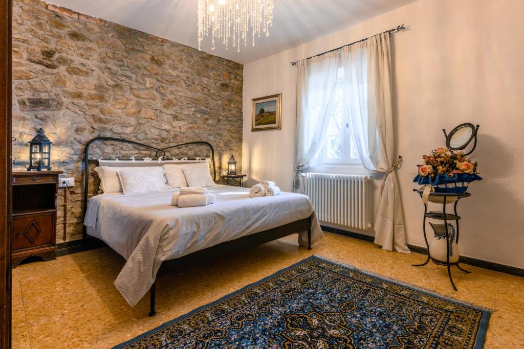a bedroom with a bed and a brick wall at Villa Marino in San Baronto