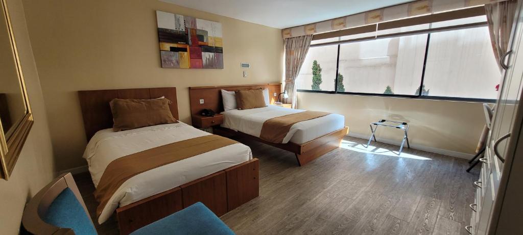 Postel nebo postele na pokoji v ubytování Hotel Carolina Montecarlo