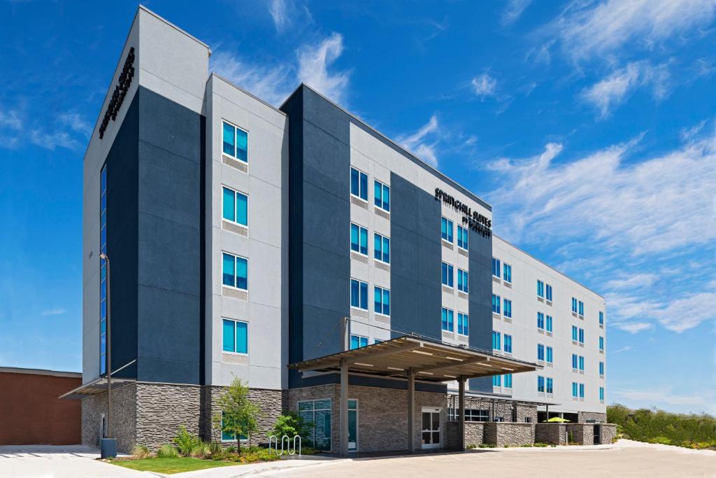 a hotel building with a blue sky in the background at SpringHill Suites by Marriott Austin Northwest Research Blvd in Austin