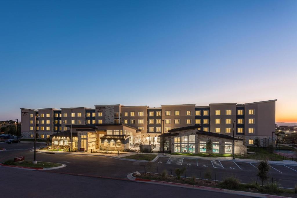 a large building with a parking lot in front of it at Residence Inn by Marriott Austin Lake Austin/River Place in Four Points