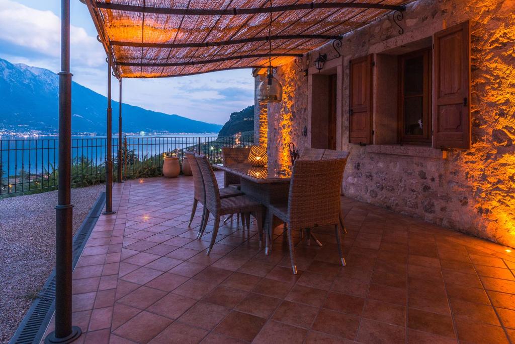 a table and chairs on a patio with a view at Villa Limone in Limone sul Garda