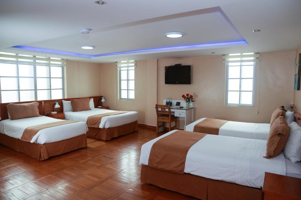Postel nebo postele na pokoji v ubytování Hotel Carolina Montecarlo