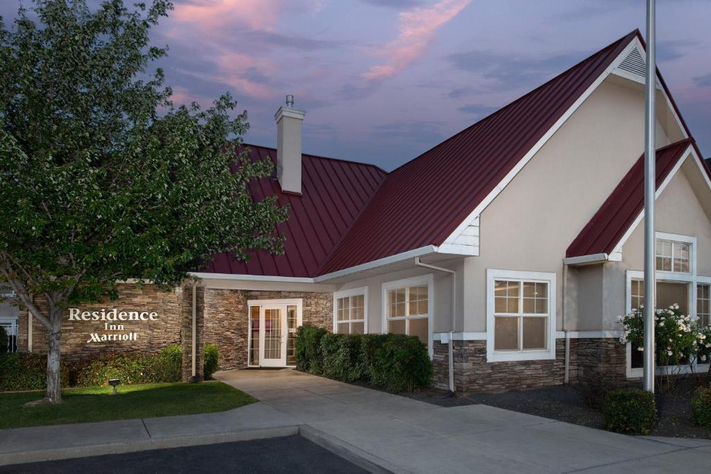 a home with a red roof and a residence atrium at Residence Inn Chico in Chico