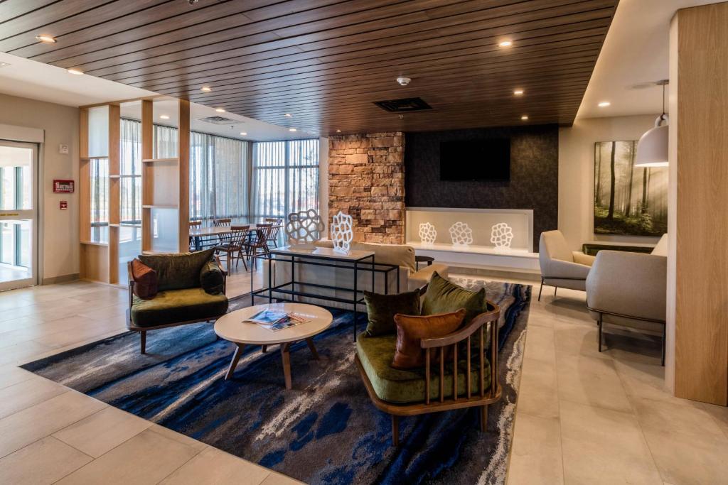 een lobby met stoelen en een tafel in een kamer bij Fairfield Inn & Suites by Marriott Brownsville North in Brownsville