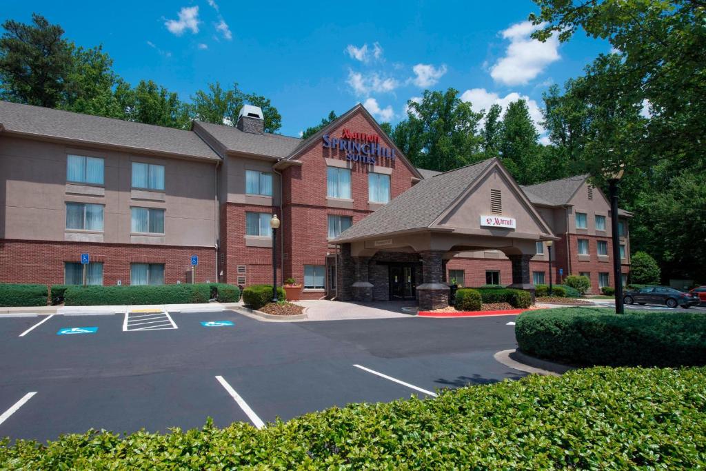 a hotel with a parking lot in front of it at SpringHill Suites by Marriott Atlanta Alpharetta in Alpharetta