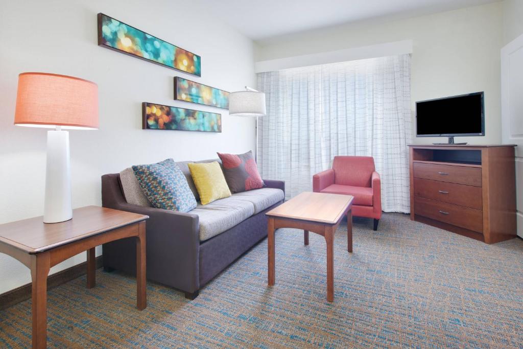 a living room with a couch and a tv at Residence Inn Midland in Midland