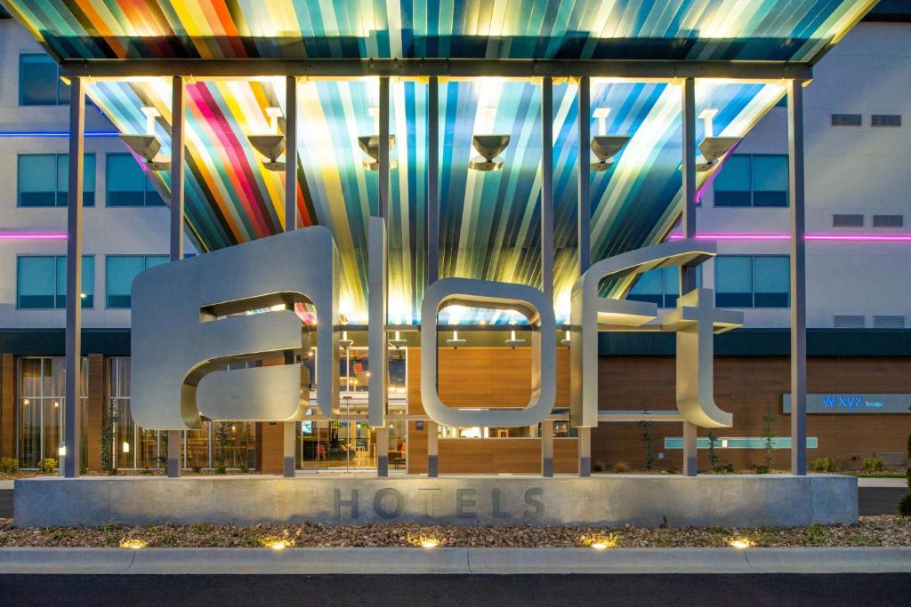 a building with a sign that reads the word ice at Aloft North Kansas City in Kansas City