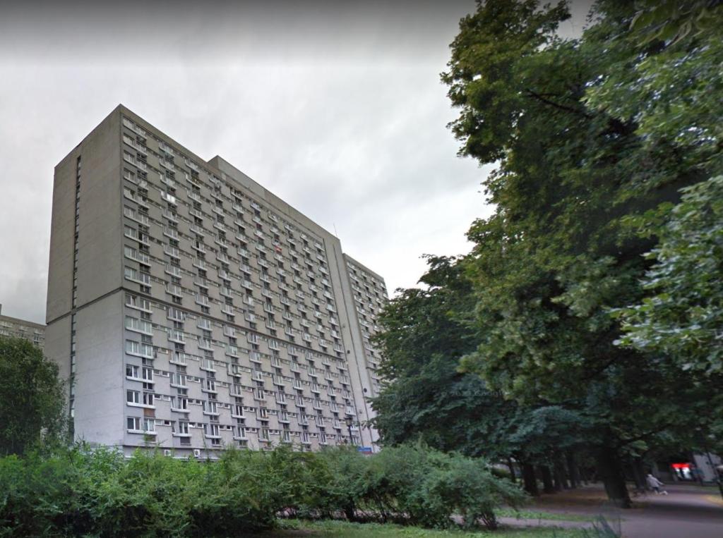 a large white building with trees in front of it at Mirovski Apartment in Warsaw