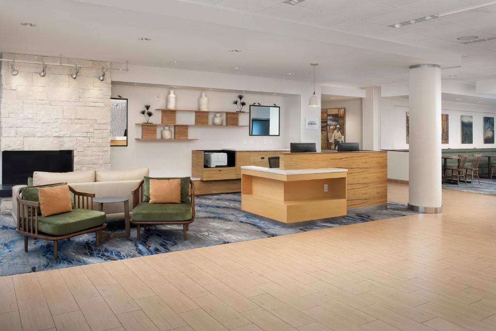 a lobby with a table and chairs and a fireplace at Fairfield Inn & Suites Baltimore BWI Airport in Linthicum Heights