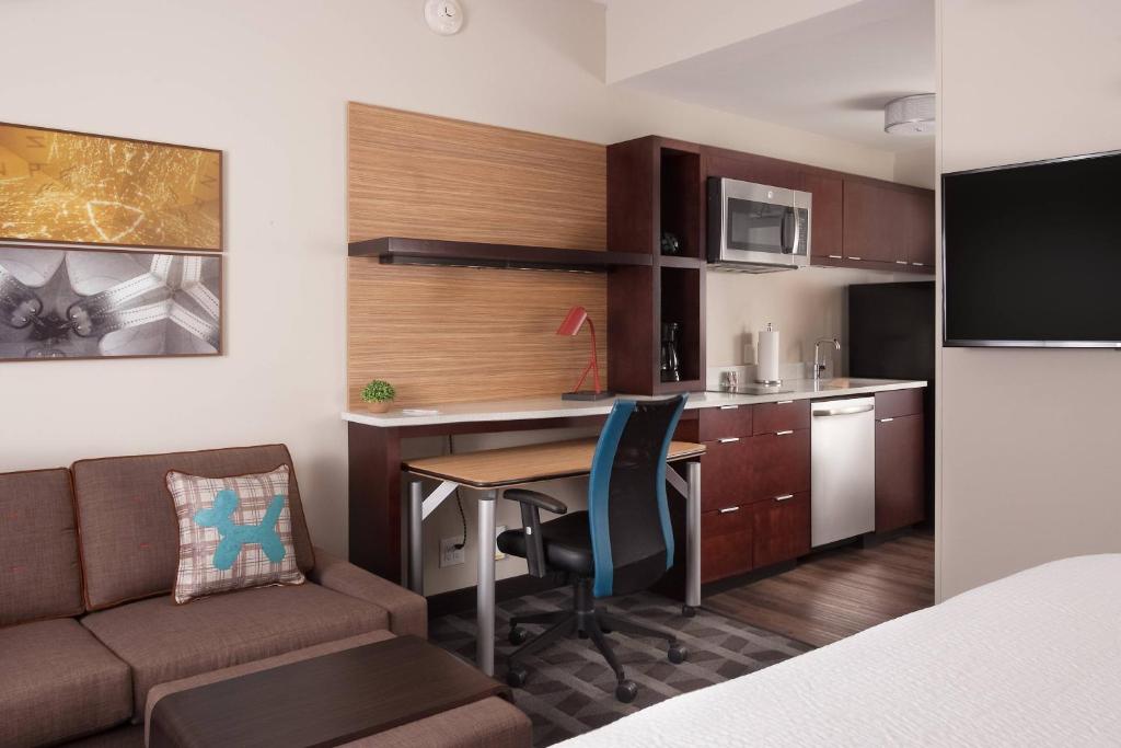 a small kitchen with a desk and a table in a room at TownePlace Suites by Marriott Charleston Airport/Convention Center in Charleston