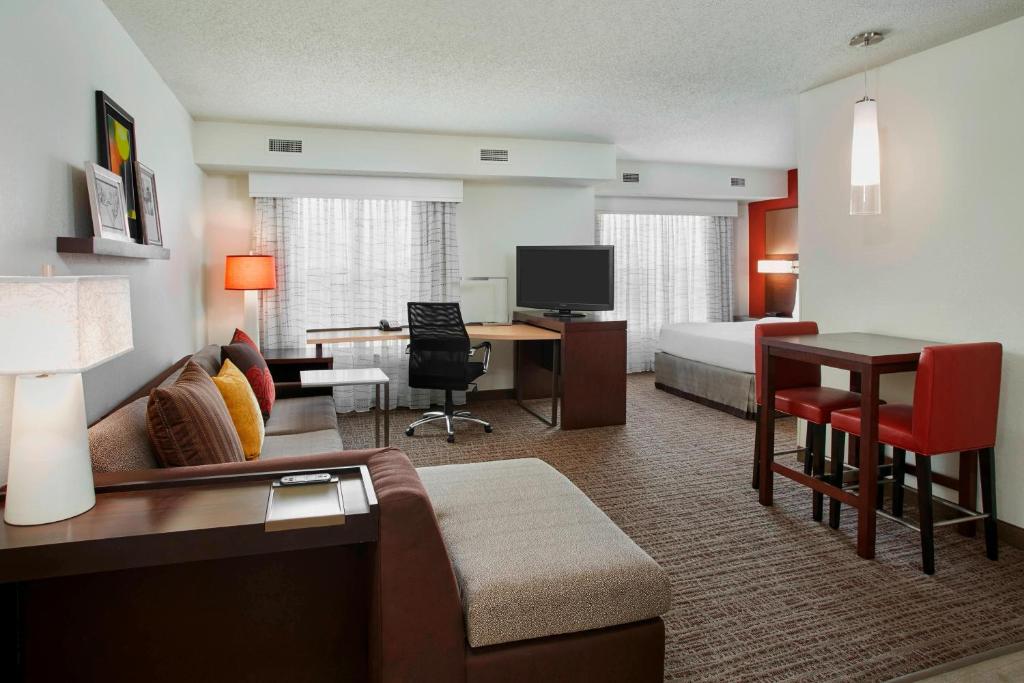 a hotel room with a bed and a living room at Residence Inn Detroit / Auburn Hills in Pontiac