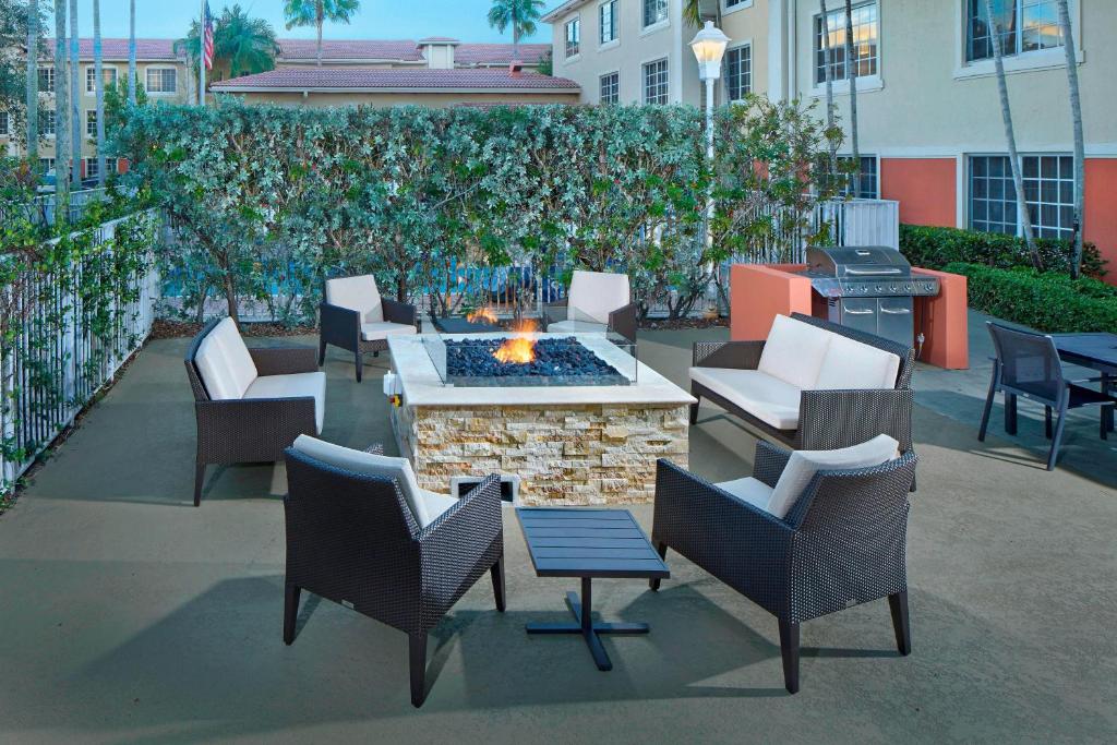 a patio with a fire pit with chairs and tables at Residence Inn by Marriott Fort Lauderdale Weston in Weston