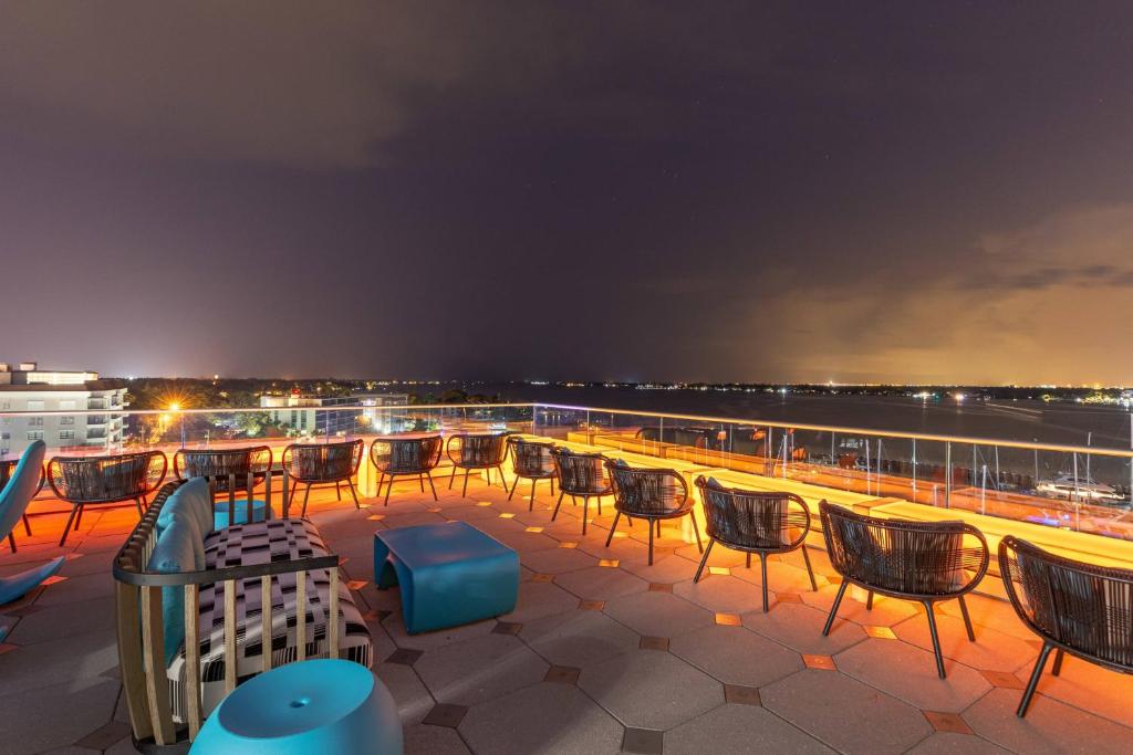 a group of chairs sitting on the deck of a cruise ship at SpringHill Suites by Marriott Bradenton Downtown/Riverfront in Bradenton